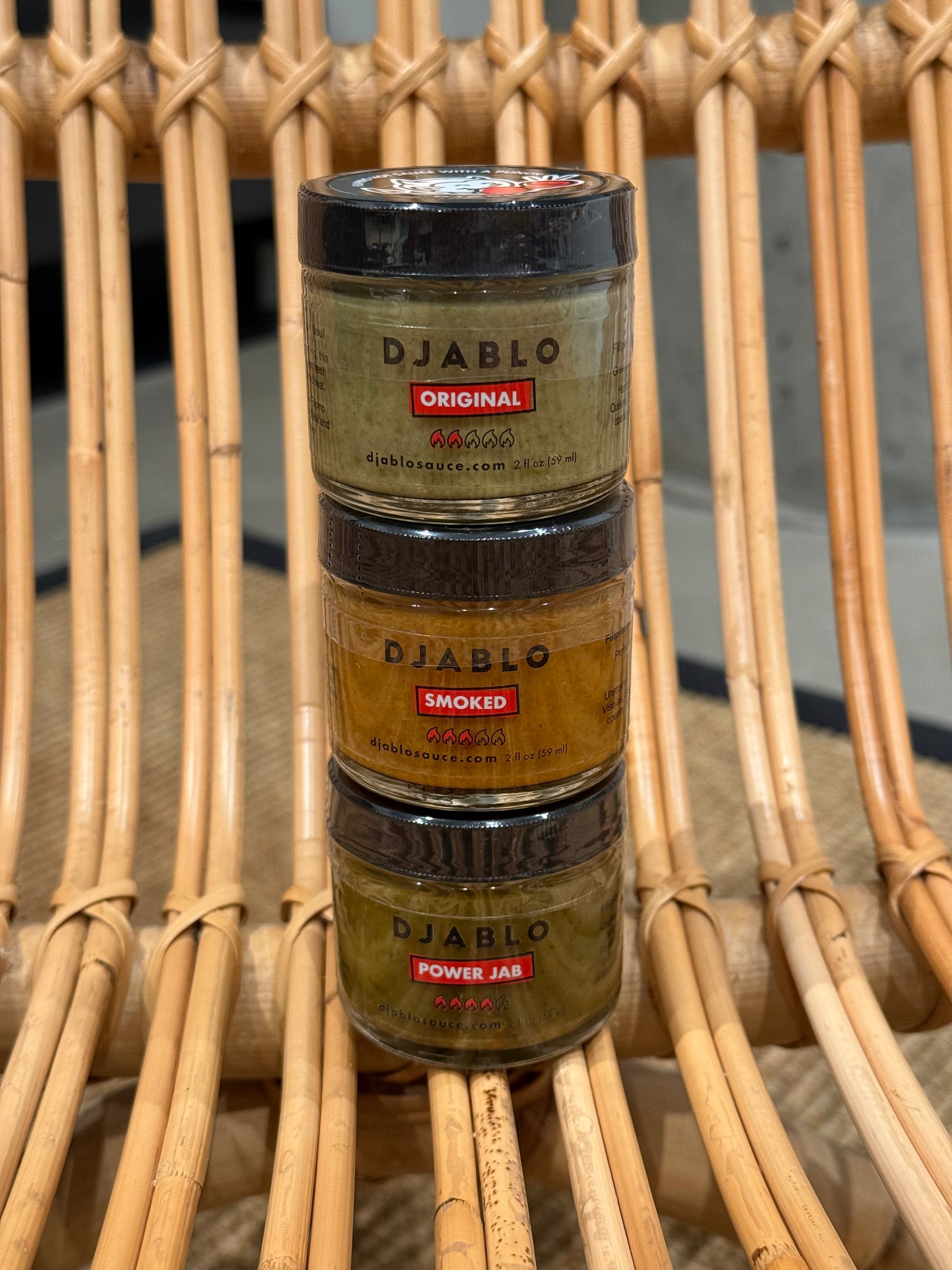 Three jars of Djablo on a woven surface