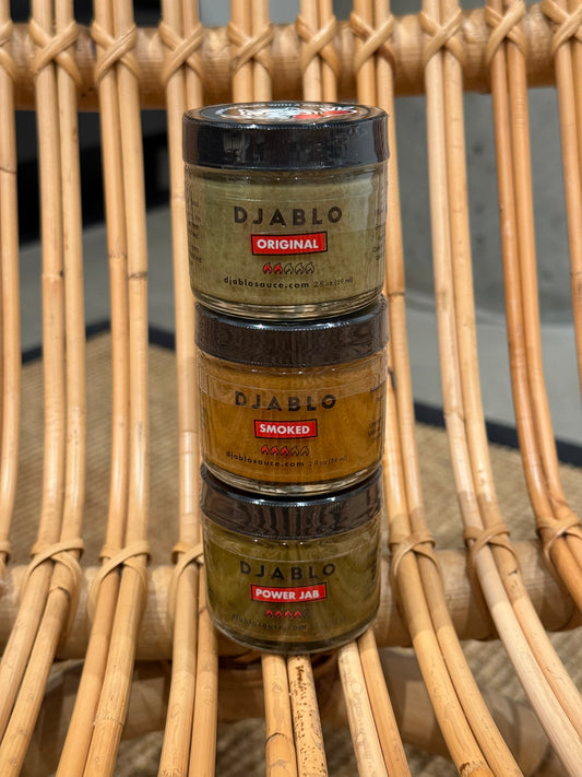 Three jars of Djablo on a woven surface